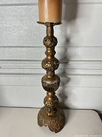 Full view of brass candlestick with faux candle
