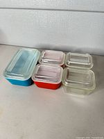Front view of all dishes showing colors and lids