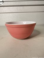 Side view of pink Pyrex mixing bowl showing exterior color and shape