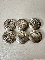 Front view showing all six patterned buttons