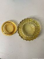 Both amber glass ashtrays side by side