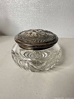 Front angled view of jar showing crystal cutting and silver lid