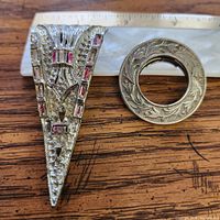 Front view of both brooches with ruler for scale