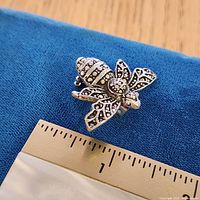 Top view showing full bee brooch and ruler for scale