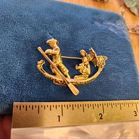 Front view showing full brooch next to ruler