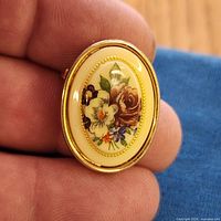 Front view showing floral design and gold-tone frame