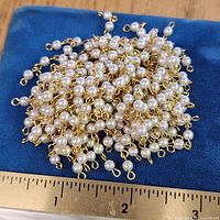 Top view showing clustered faux pearls and ruler for scale