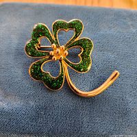 Front view of brooch showing clover shape and enamel