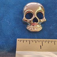 Front view showing skull shape, rhinestone teeth, ruler for size