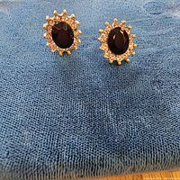 Pair of earrings on cloth showing overall design