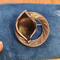 Front view showing abstract design and gold-tone finish