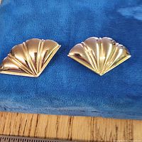 Front view of both gold-tone fan-shaped clip-on earrings