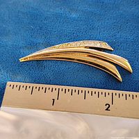 Front view showing full brooch with ruler for scale