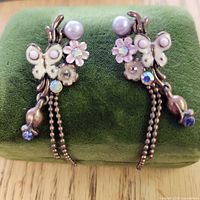 Front view of both earrings on display cushion