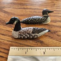 Both wood bird brooches with ruler for scale