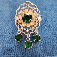 front view showing brooch design and stones