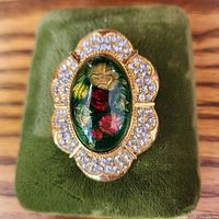 Front view showing cabochon, rhinestone border and overall design