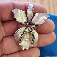 Front view showing purple center stone and clear accent