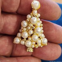 Front view of gold-tone Christmas tree brooch with faux pearls