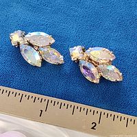 Front view of both earrings beside ruler showing about 1-inch length