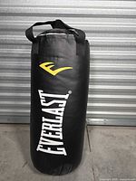Full view of Everlast black heavy bag standing upright