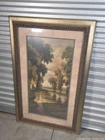framed landscape print leaning against wall showing full front view