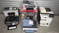 Group view of five printers with two Canon boxes