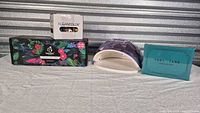 Group shot of all four items: nail lamp, Beetles kit, KleanColor set, board game