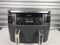 Front view of Ninja DualZone air fryer showing two baskets and overall condition