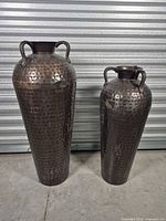 Front view of both hammered copper vases showing sizes and finish
