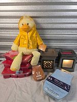 Full lot view: plush duck, two warmers, stack of wax bars and brick