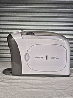 Left side profile of Sienna TriShine cleaner showing logo and housing