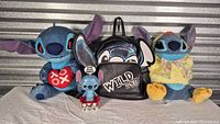 Group shot showing both plush toys, backpack, and Funko figure
