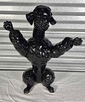 Front view of black ceramic poodle figurine