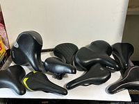 All eight saddles laid out on table