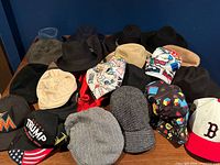 All hats laid out on table for quantity and variety overview