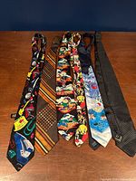 Six ties laid flat showing full designs