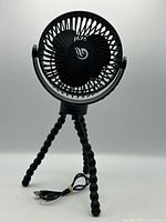 Front view of black portable fan on flexible tripod