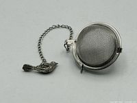 Whole infuser showing mesh ball, chain and bird charm