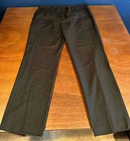 Full view of black dress pants laid flat