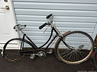 Full view of Raleigh Tourist frame showing missing rear wheel and overall condition
