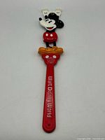 Full view of 16" red plastic Mickey Mouse back scratcher