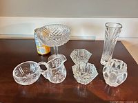 Group shot of all seven clear glass items on table