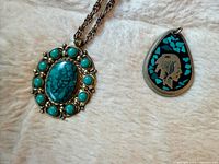 Both pendants side by side showing overall design and size contrast