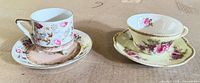 Both tea cup and saucer sets side by side displaying patterns