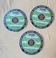 Front view of three baggage labels showing design and colours