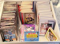 Box containing multiple sections of stacked NHL trading cards showing fronts and a promotional insert