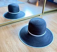 Sun hat front view reflected in mirror showing brim and white trim