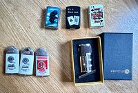 All seven lighters grouped, including Mantello in box