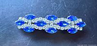 Front view showing blue marquise and clear round rhinestones
